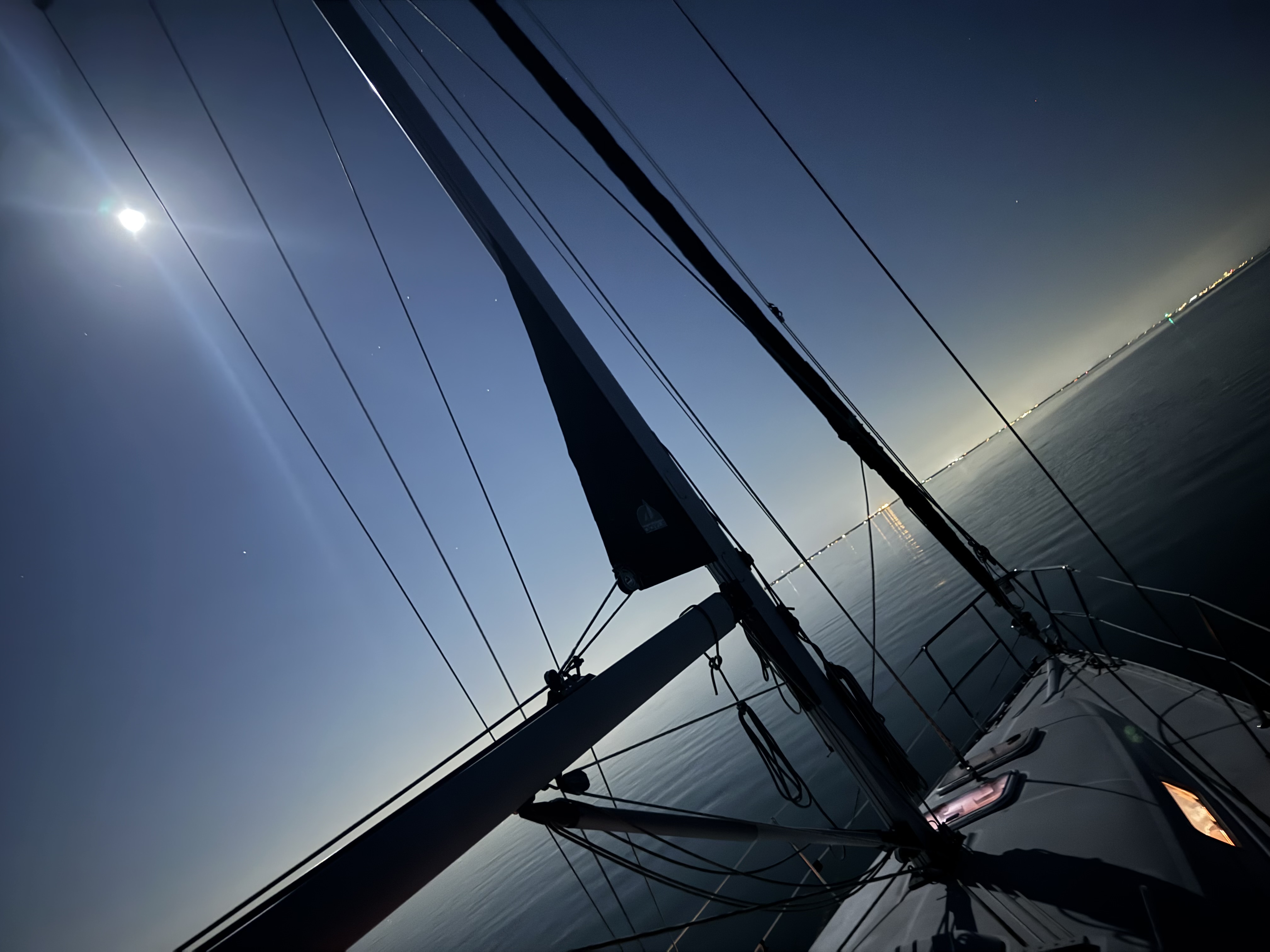 Moon rising over Northern Lights at anchor